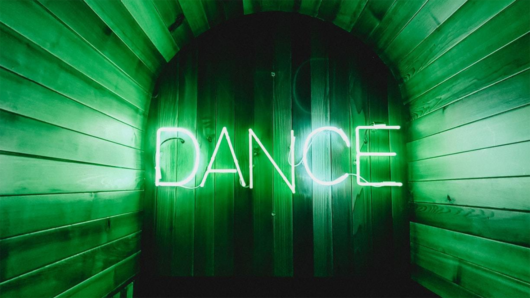 A neon sign of the word "Dance"