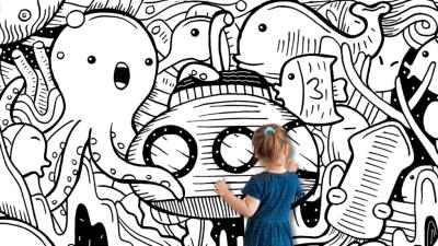 Illustration of a wall covered in drawings of sea creatures with two young children drawing and coloring it in