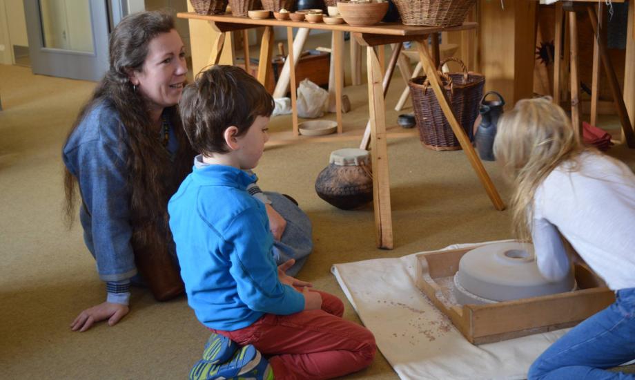 Anglo-Saxon reenactors teaching children about food preparation