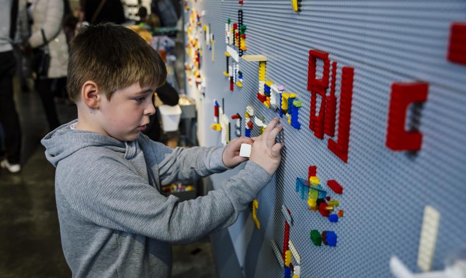 Boy using Lego Wall. Photo James Mulkeen