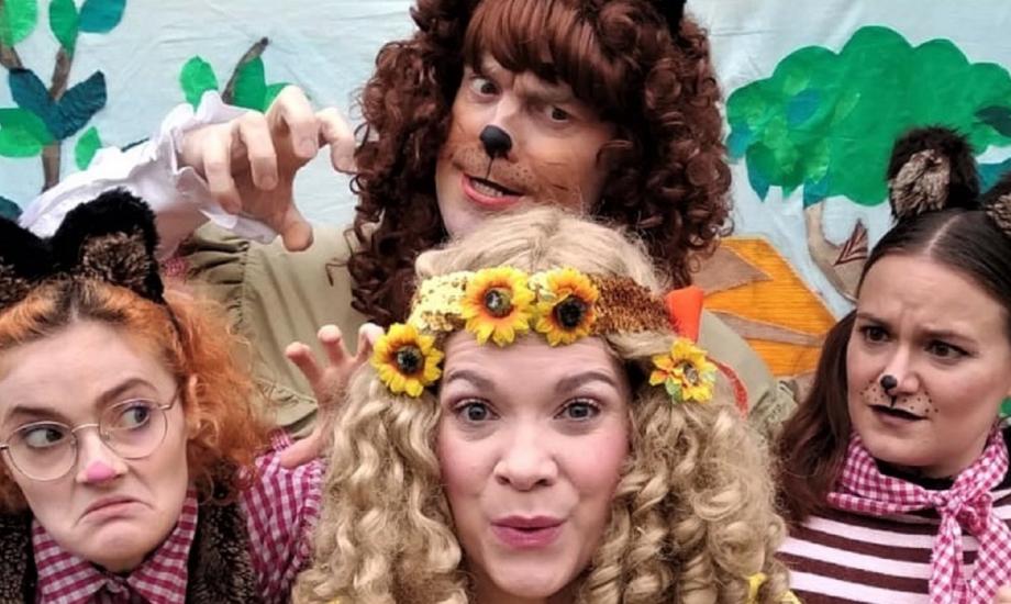 Three actors dressed as Goldilocks and the three bears