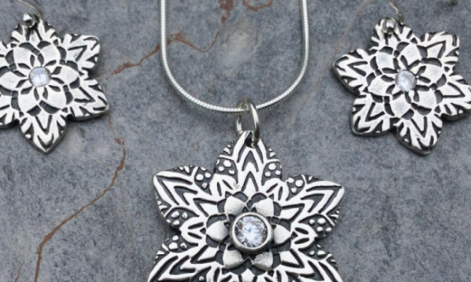 Three flower shaped silver necklaces with central stones