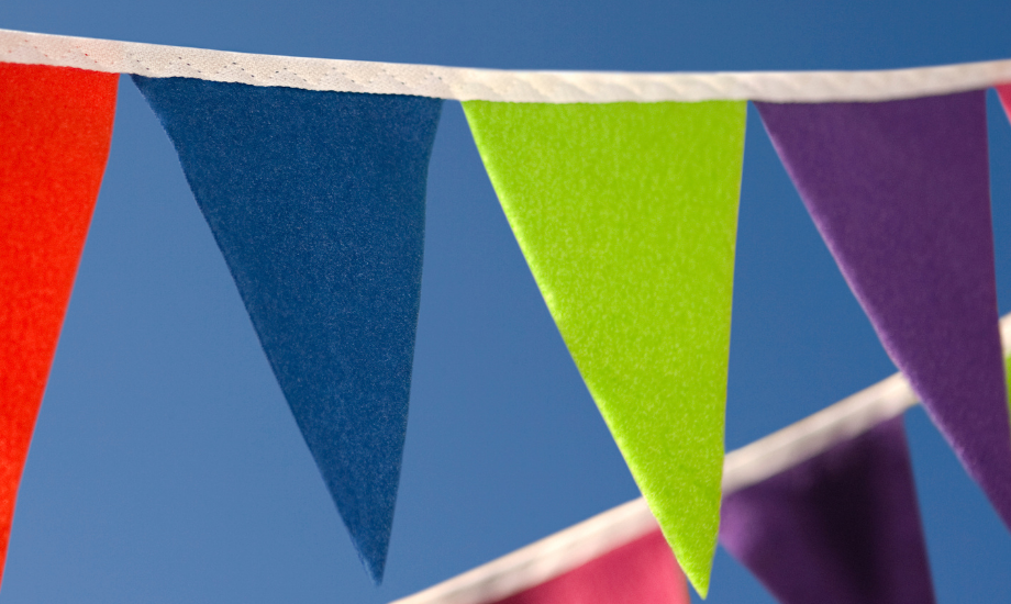 colourful fabric bunting against a bright blue sky