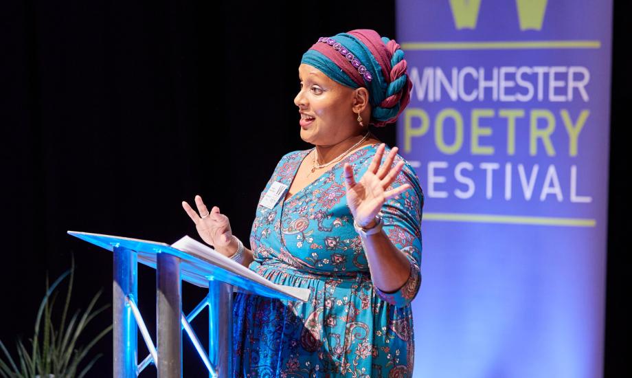 Hampshire Poet Nazneed ahmed Pathak speaking in front of a lectern